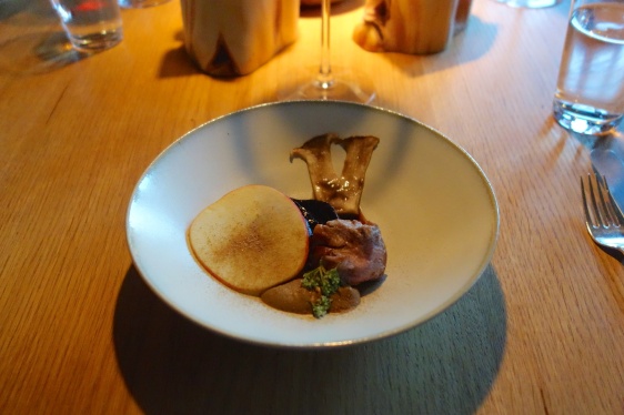 Spring lamb baked in birch bark with thinly sliced raw mushrooms and a puré of smoked apples & mushrooms served with onions in fermented blueberry